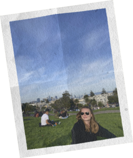 Isabel in a San Francisco park with the city skyline behind